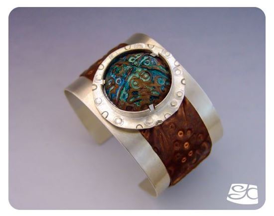 Picture of Handmade sterling silver cuff with foldformed tab-set copper cabochon.